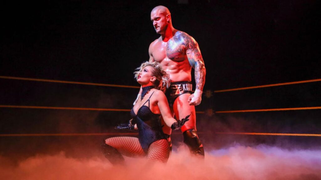 Karrion Kross stands in ring with manager Scarlett at his side
