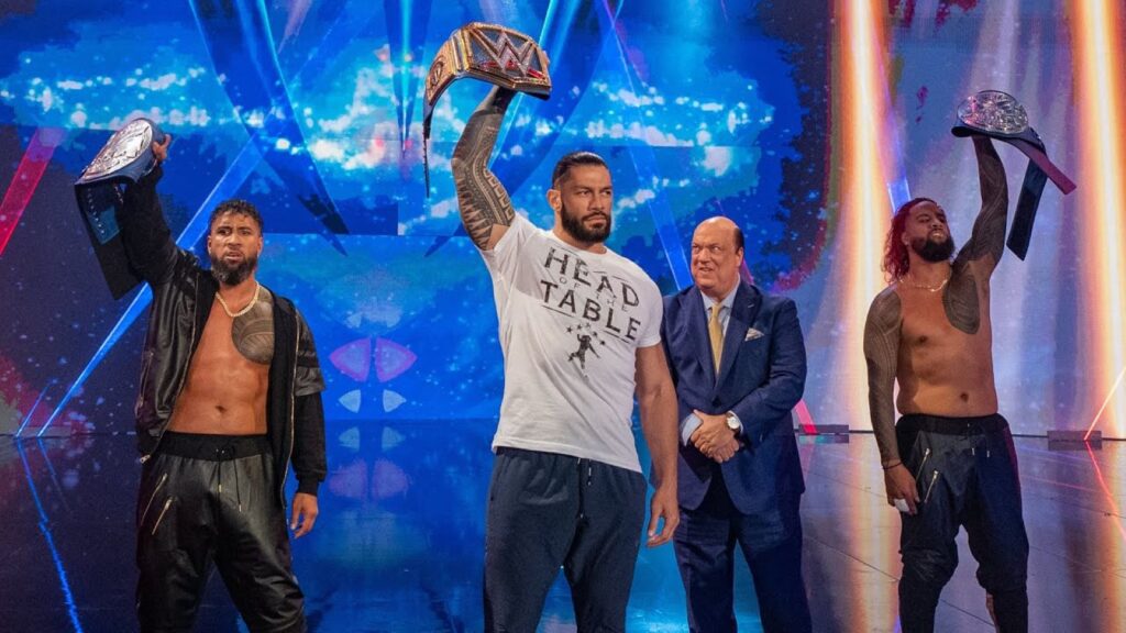 The Usos, Roman Reigns, and Paul Heyman stand on WWE entrance ramp